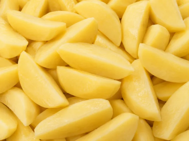 Freshly prepared quarter cut potatoes