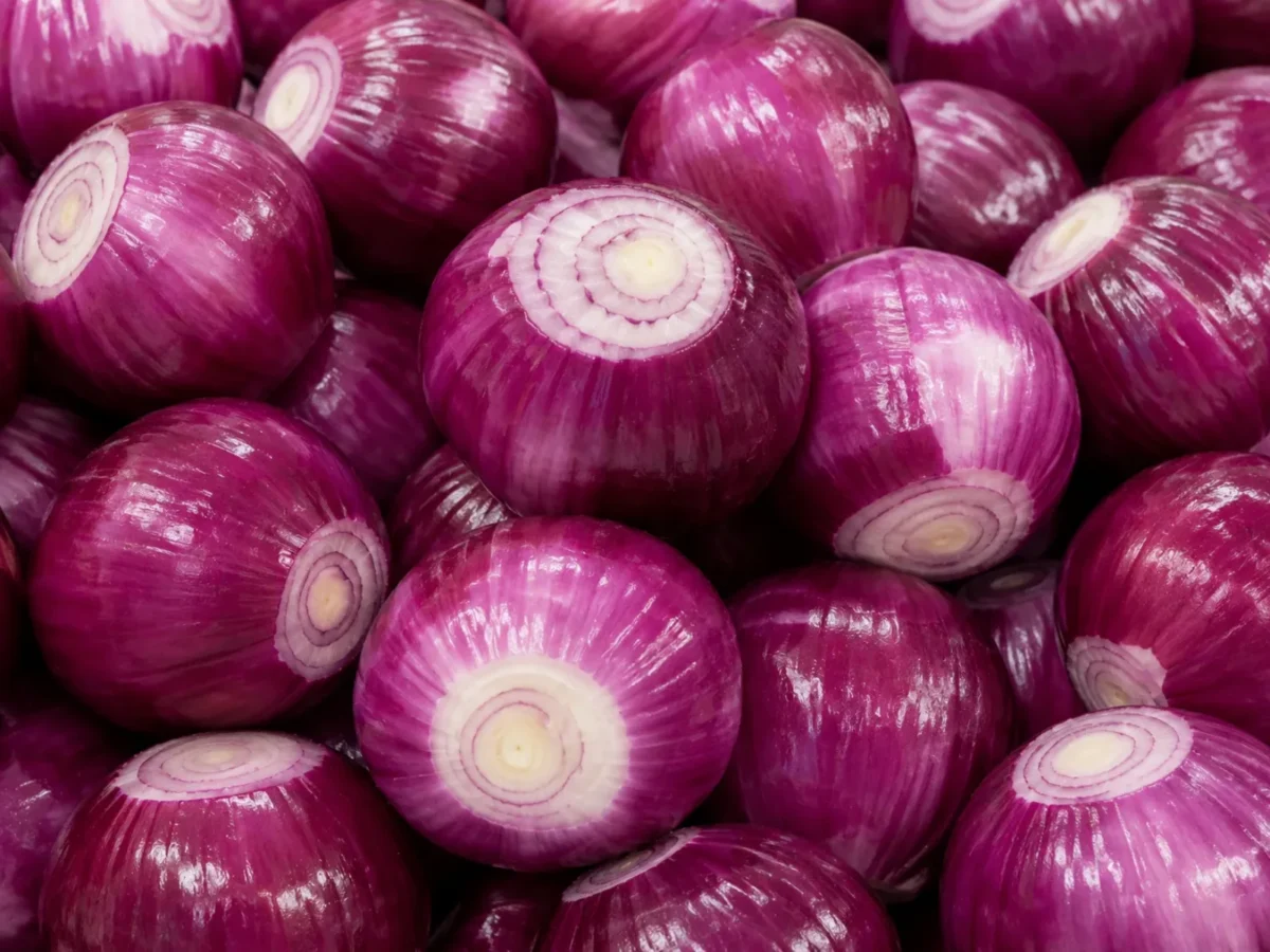 Freshly prepared whole peeled red onions